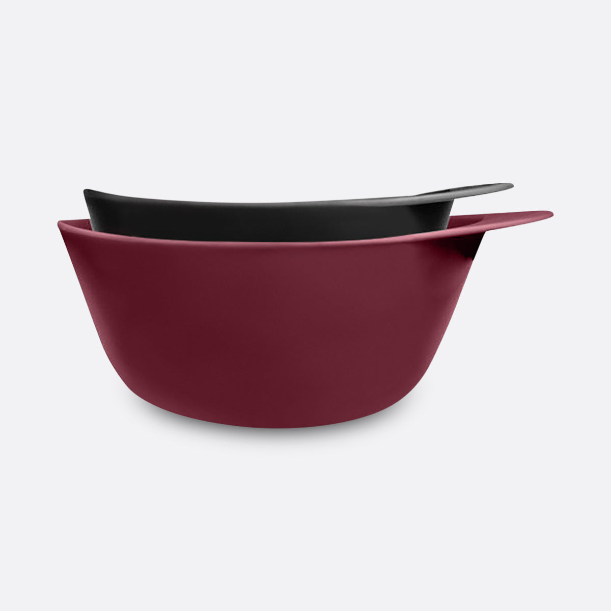 Set of two bowls, one burgundy and one black, on a light gray background