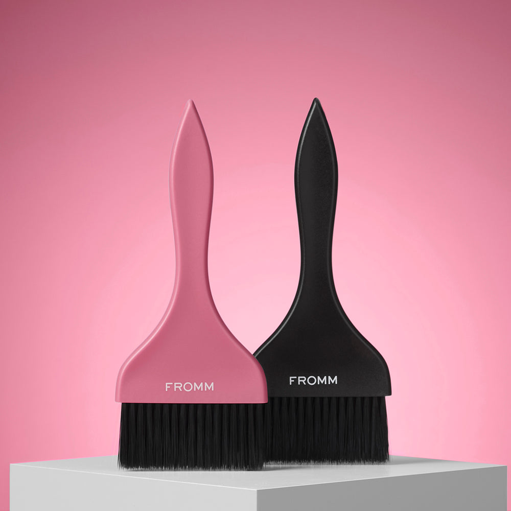 Two paint brushes, one pink and one black, with 'FROMM' branding on a pink background.