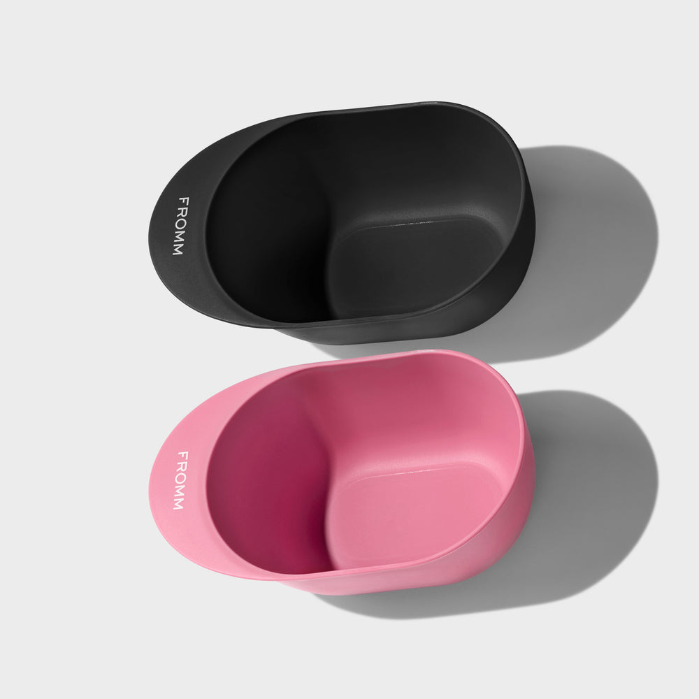 FROMM branded color bowls one in black and the other in pink on a light grey background