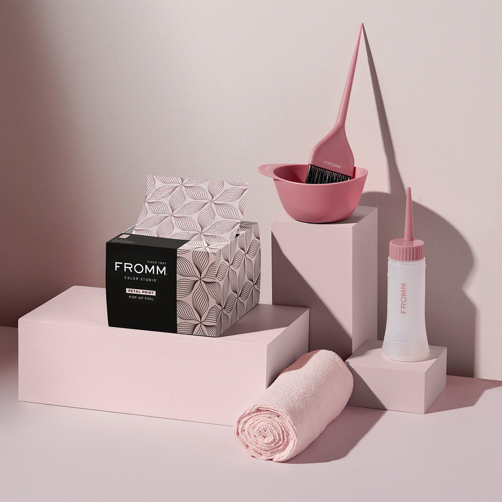 A collection of Fromm pink petal foils, pink color bowl, pink color brush and pink applicator bottle.