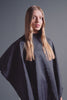 Blonde model wearing FROMM black hairstyling cape 