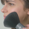 FROMM Neck Duster brushing hair off a models face in a video
