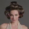 A video of a model with rollers in her hair